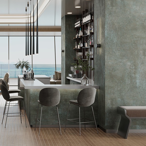 A ship lounge is covered with green stone recalling the surrounding sea landscape 